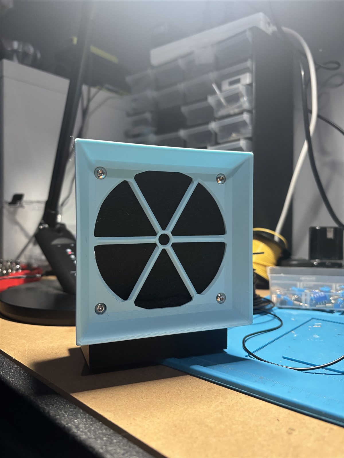Front view of the blue 3D-printed fume extractor enclosure around its fan