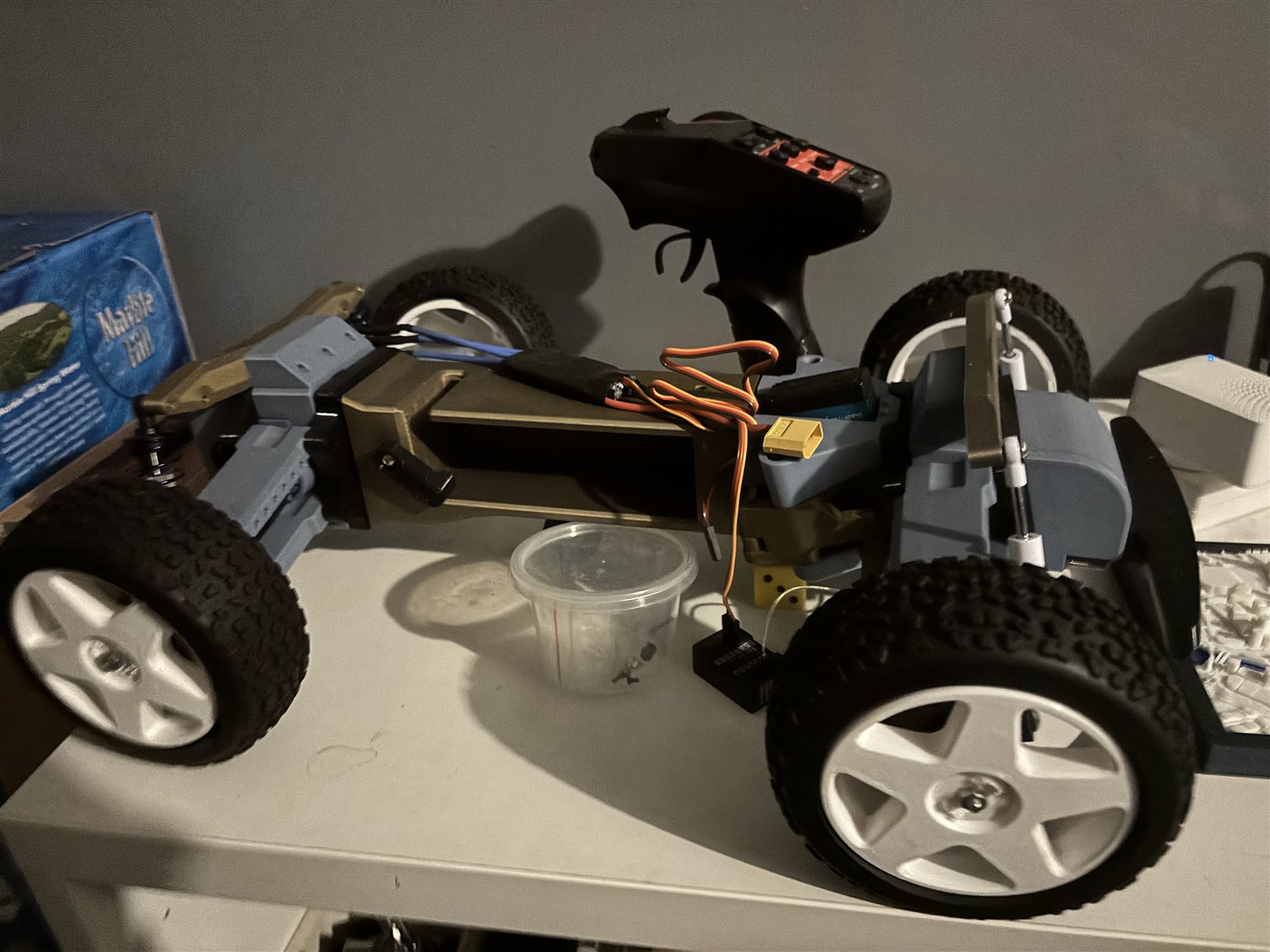 Side view of the TARMO5 RC car during assembly with transmitter and wiring visible